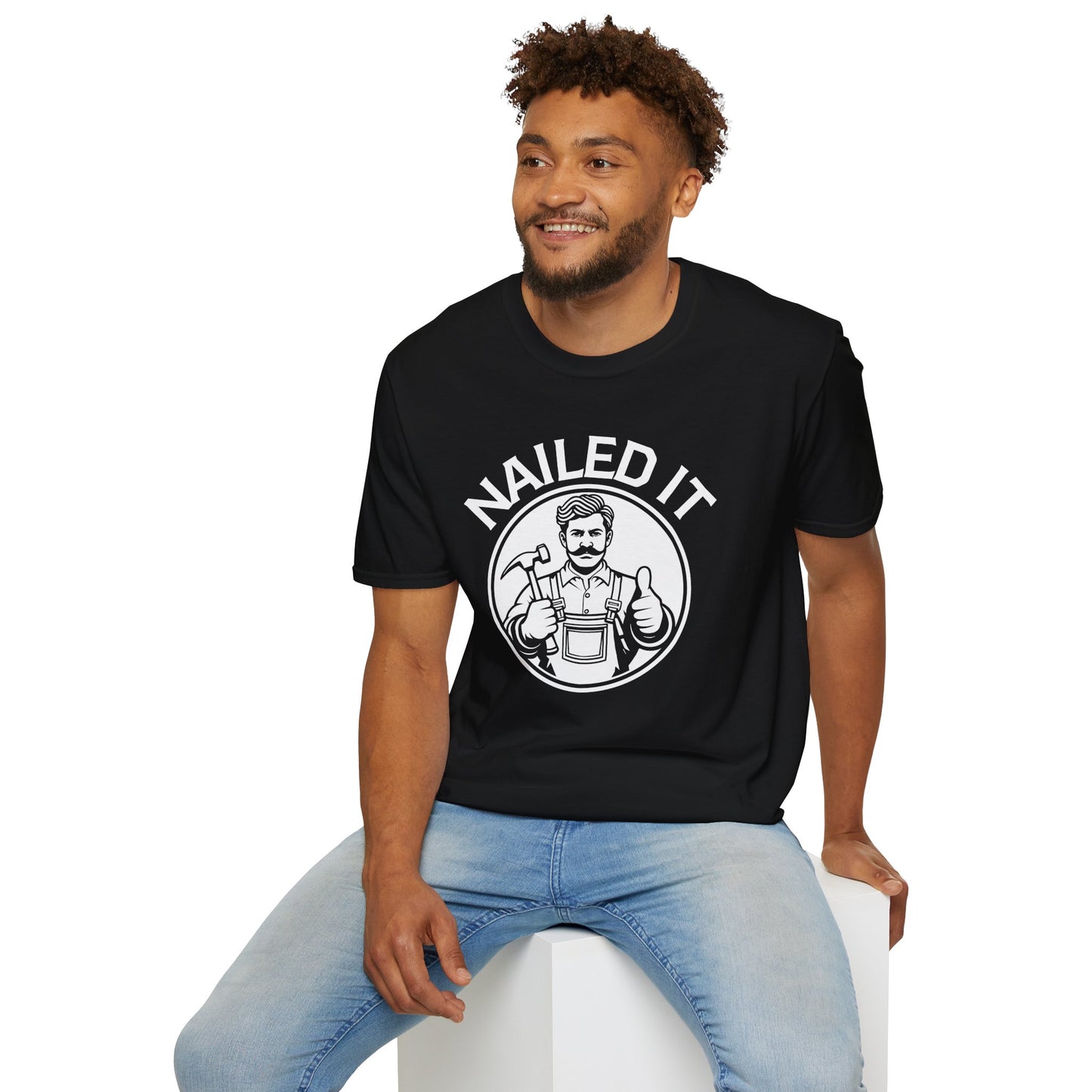 Man wearing a black t-shirt with 'NAILED IT' graphic design on a white background