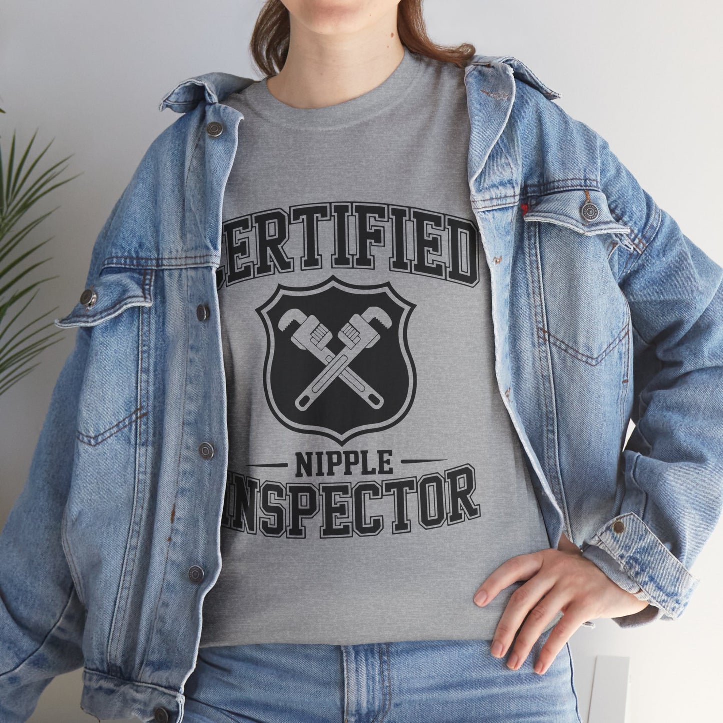 Person wearing a gray t-shirt with 'Certified Nipple Inspector' text and denim jacket.