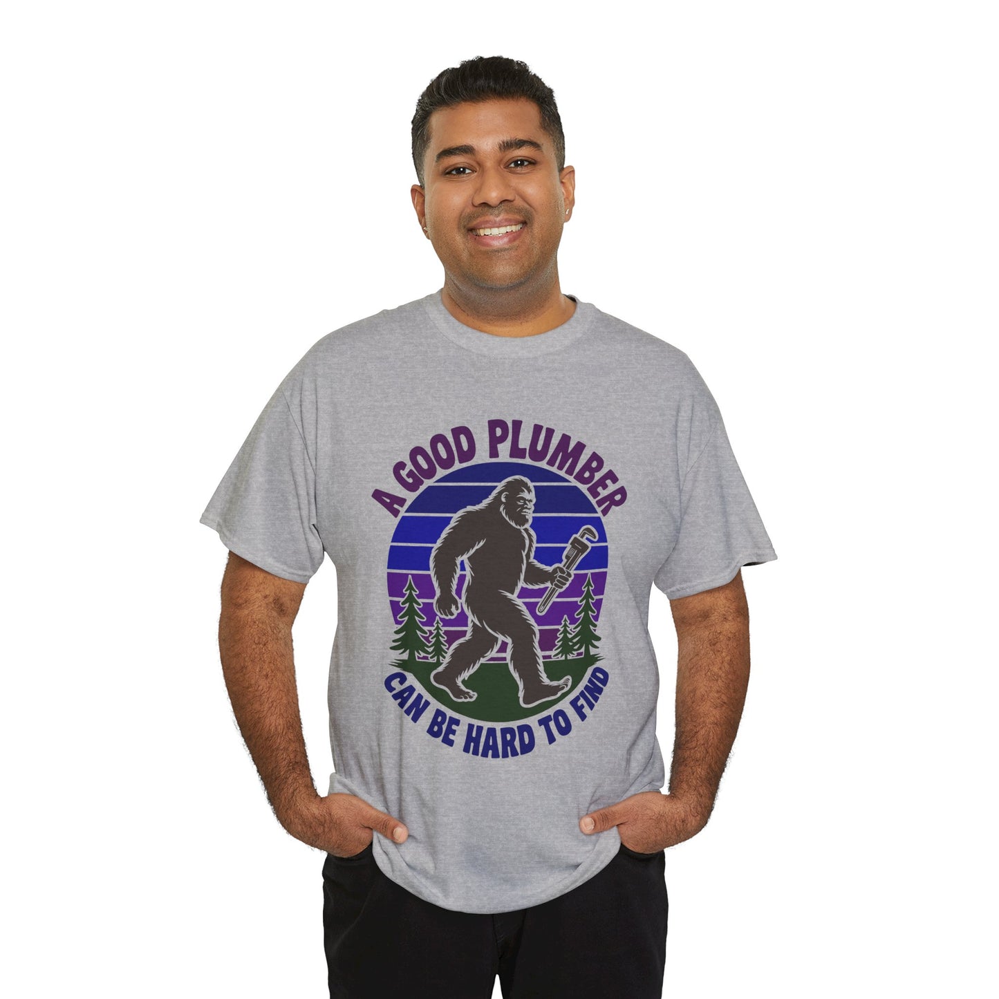 Man wearing a Gray t-shirt with a graphic of a bigfoot-like creature holding a wrench and text 'A Good Plumber Can Be Hard to Find' on a white background.