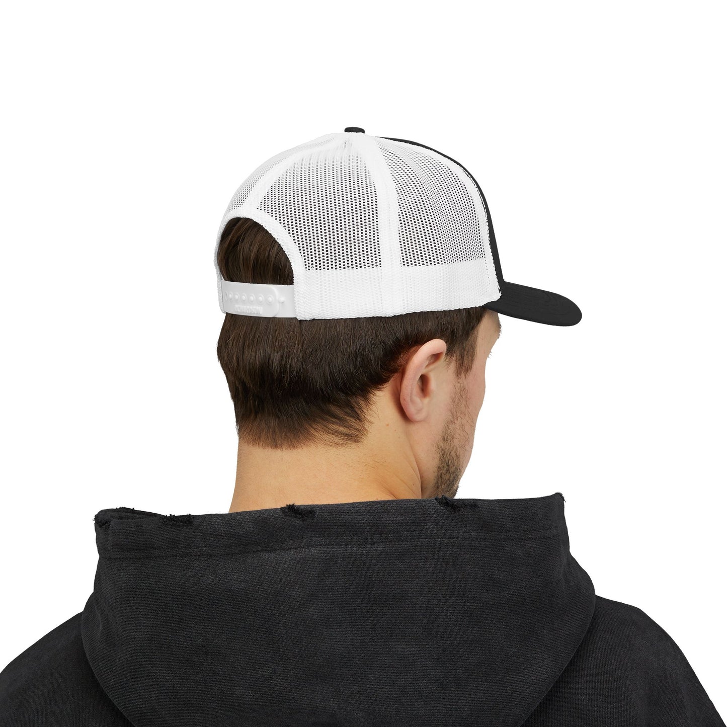 Person wearing a black hoodie and a white and black cap on a white background