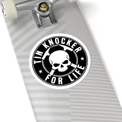 Skateboard with a 'Tin Knocker for Life' sticker on a white background
