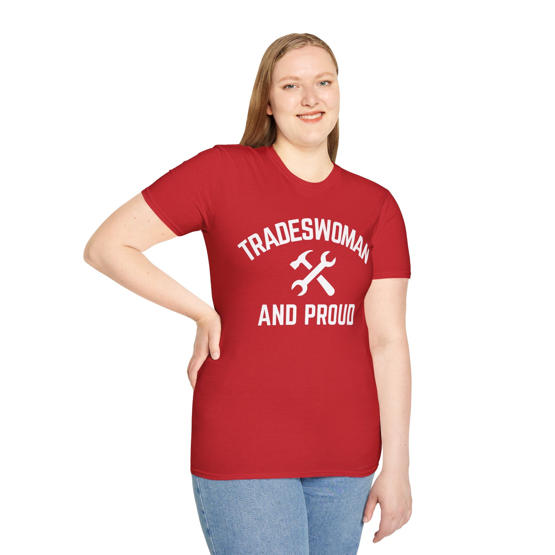 Woman wearing a red t-shirt with 'TRADESWOMAN AND PROUD' text and a wrench graphic on a white background