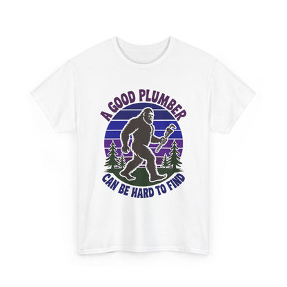 White t-shirt with a graphic of a bigfoot holding a wrench and text 'A Good Plumber Can Be Hard To Find' on a white background.