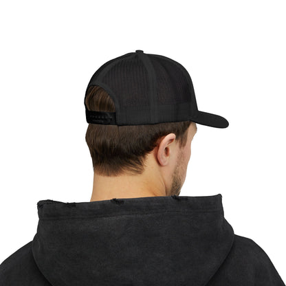 Person wearing a black cap and black hoodie on a white background