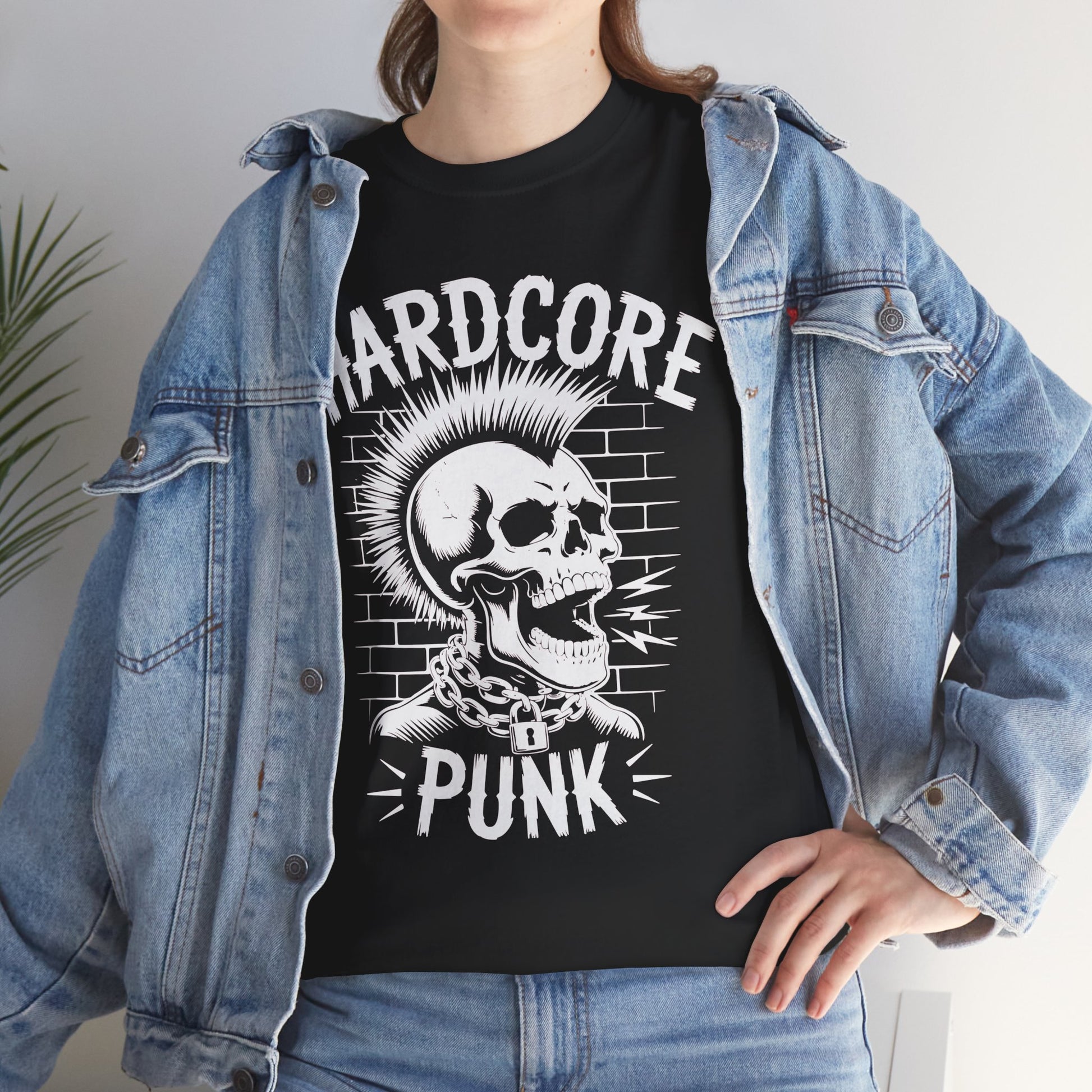 Person wearing a black t-shirt with a skull graphic and 'Hardcore Punk' text, paired with a denim jacket.