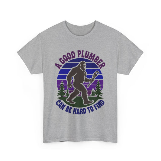 Gray t-shirt with a graphic of a bigfoot-like creature holding a wrench and text 'A Good Plumber Can Be Hard to Find' on a white background.