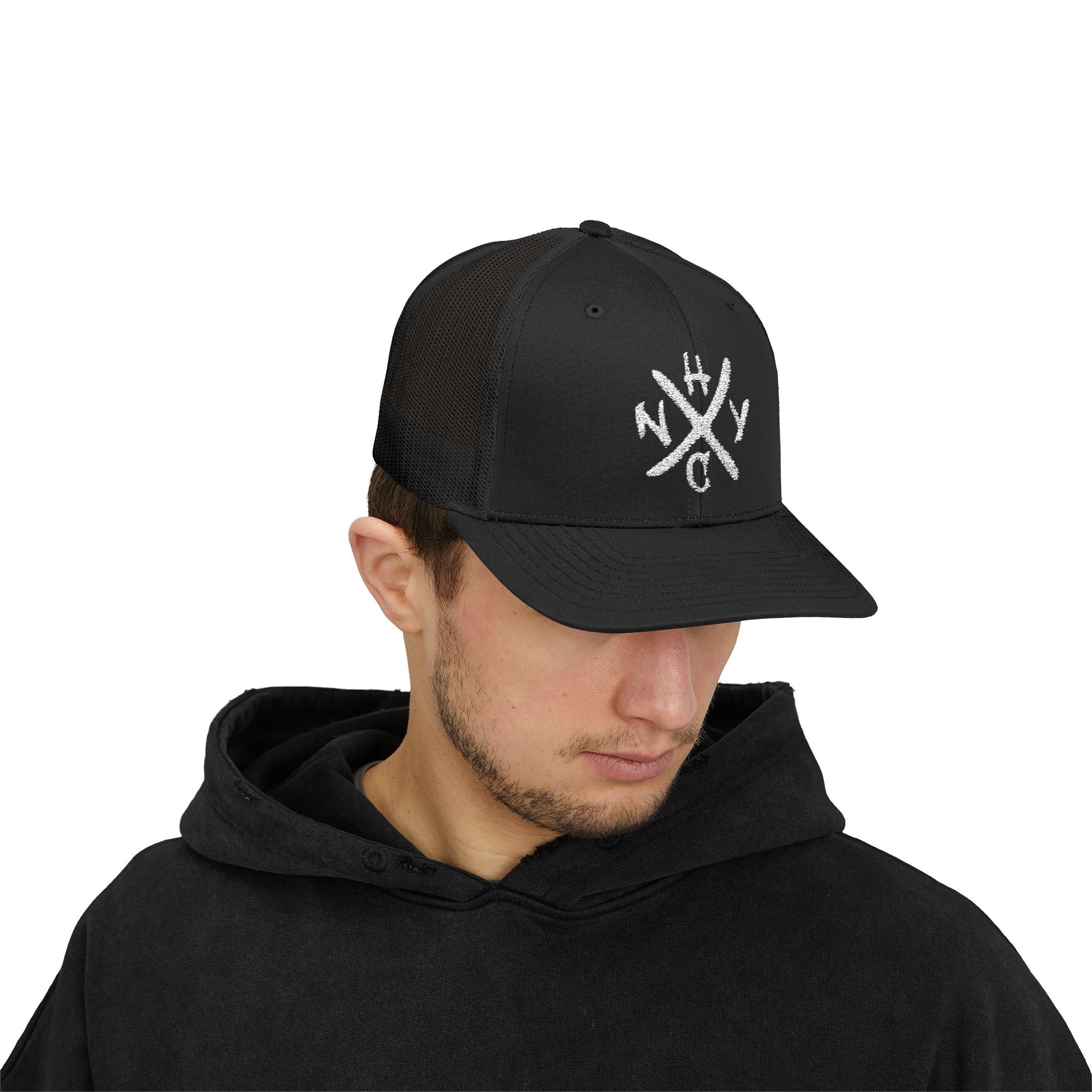 Man wearing a black cap with white NYHC logo on a white background