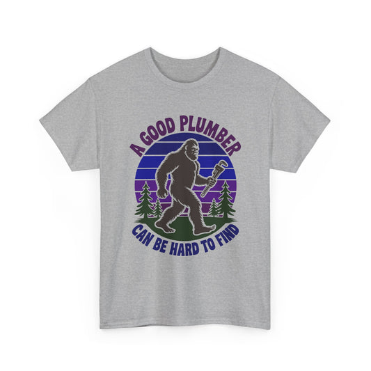 Gray t-shirt with a graphic of a bigfoot-like creature holding a wrench and text 'A Good Plumber Can Be Hard to Find' on a white background.