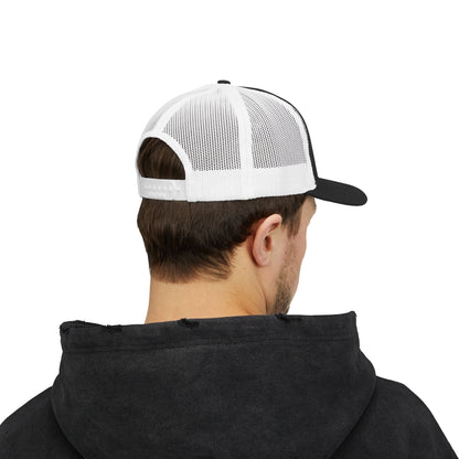 Person wearing a black hoodie and a white and black cap on a white background